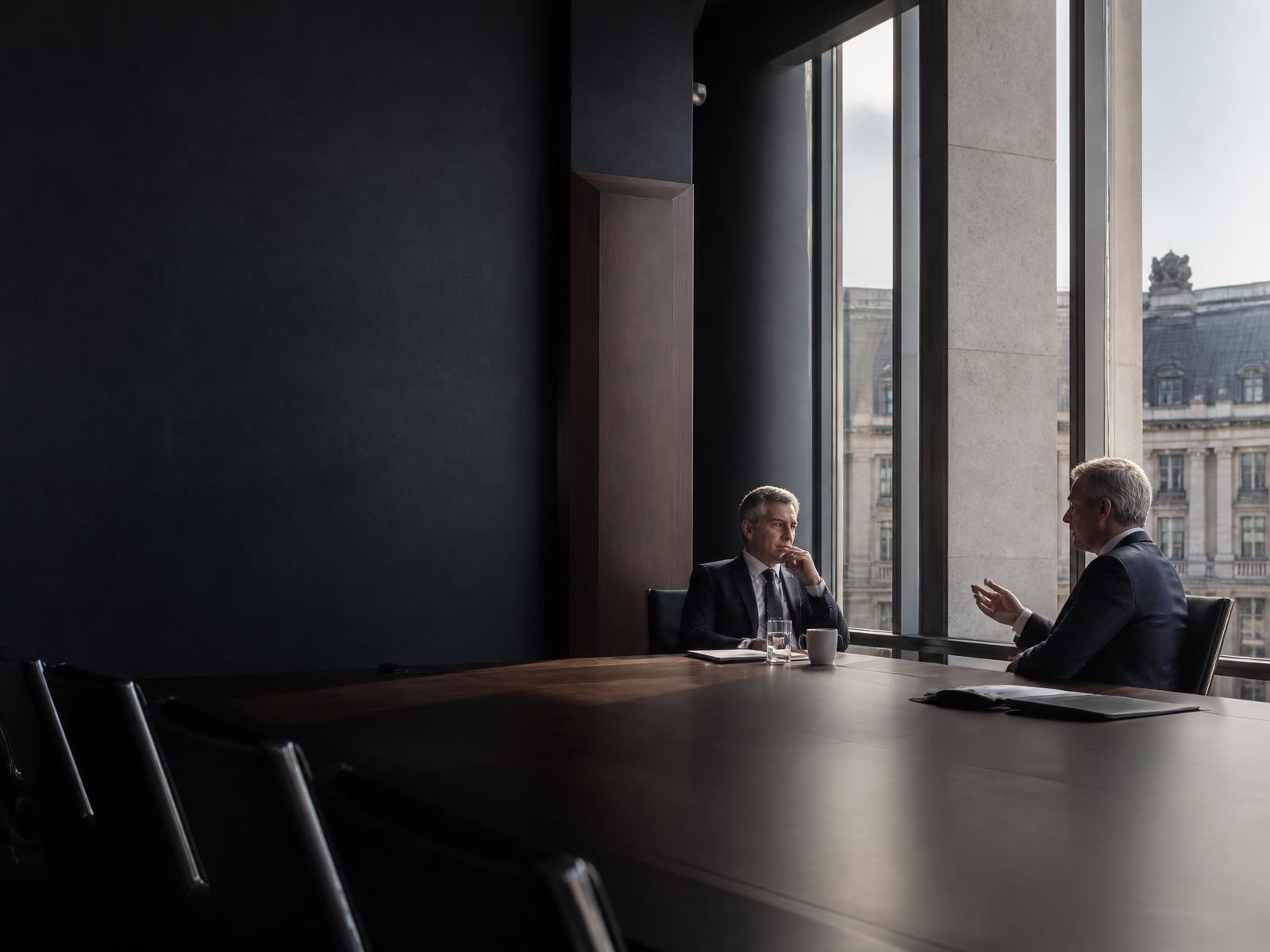 Editorial photograph of a boardroom conversation